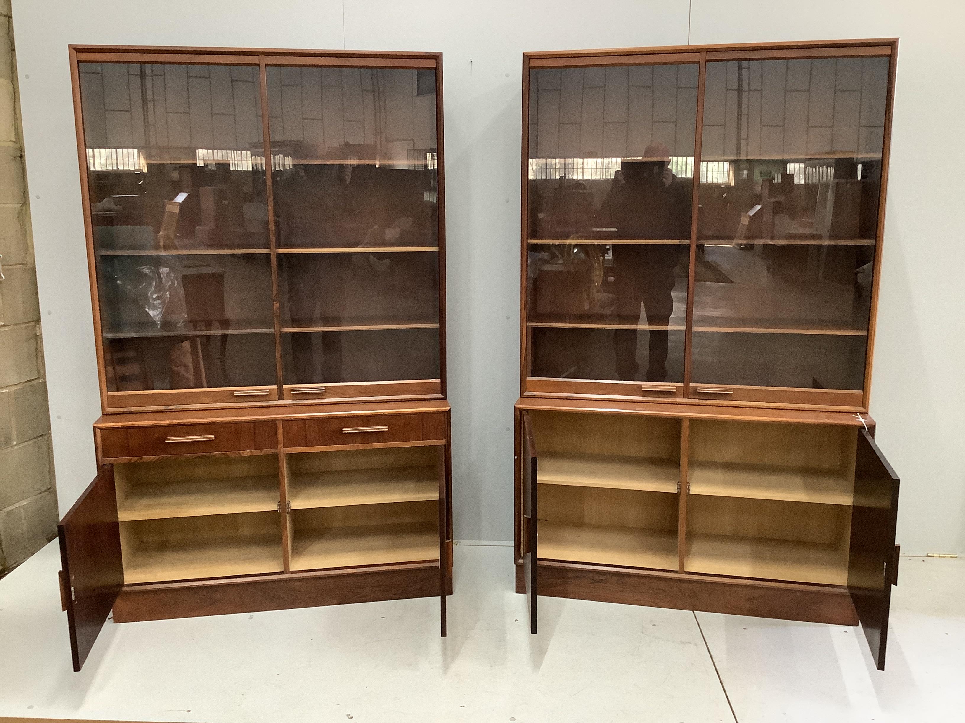 A pair of mid century Indian rosewood glazed cabinets with adjustable shelves, width 110cm, depth 38cm, height 180cm